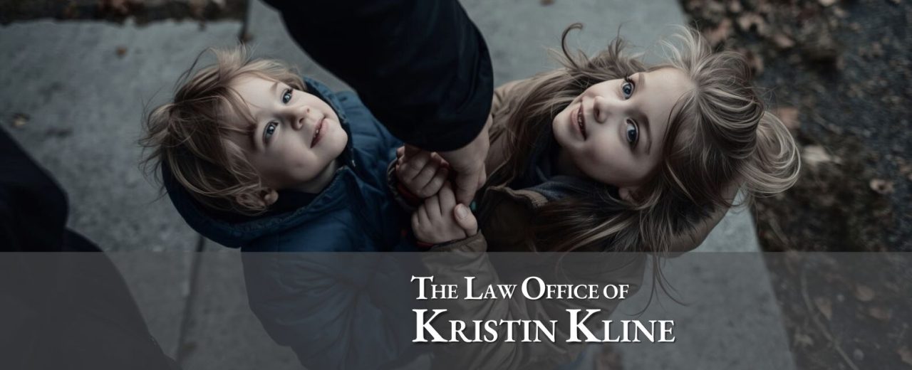 Two children smiling while holding hands, with a focus on their joyful expressions, representing the theme of co-parenting and family unity during the holidays, with branding for The Law Office of Kristin Kline.